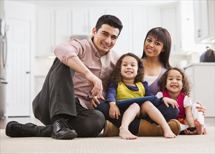 Family using tablet computer on living room floor