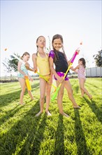 Caucasian girls playing in backyard