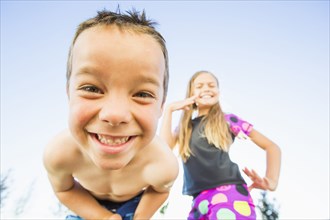 Low angle view of Caucasian children smiling outdoors