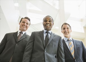 Low angle view of businessmen smiling in office