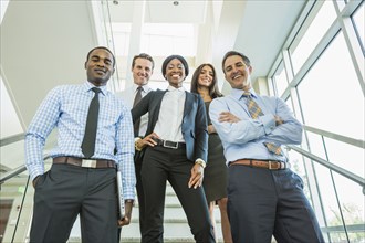 Low angle view of business people smiling on office staircase