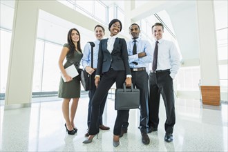 Business people smiling in office lobby