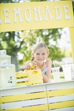 Caucasian girl smiling at lemonade stand