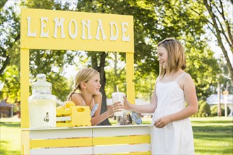 Caucasian girl buying drink at lemonade stand