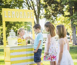 Caucasian children buying drinks at lemonade stand