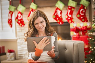 Caucasian woman using digital tablet at Christmas