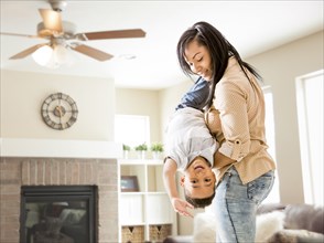 Mixed race mother and son playing in living room