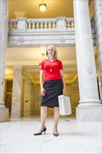 Caucasian businesswoman with briefcase in courthouse