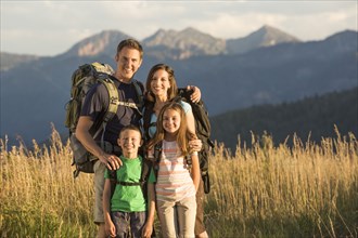 Caucasian family smiling in remote landscape