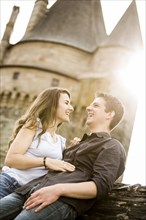 Caucasian couple smiling at castle