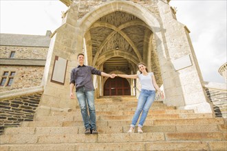 Caucasian couple standing on castle steps