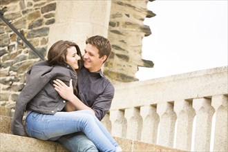 Caucasian couple hugging on castle steps