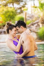 Couple hugging in swimming pool