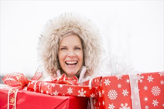 Caucasian woman carrying Christmas gifts