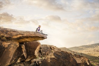 Caucasian woman sitting on rock formation