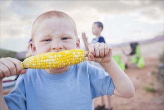 Caucasian boy eating corn on the cob