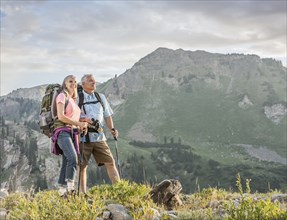 Caucasian couple hiking on mountain