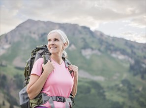 Caucasian woman hiking on mountain