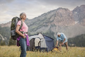 Caucasian couple camping on mountain