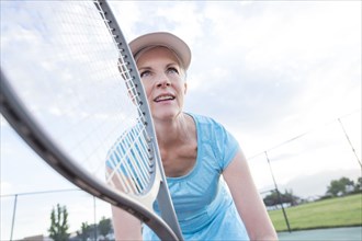 Caucasian woman holding tennis racket