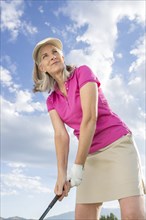 Caucasian woman holding golf club
