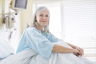 Portrait of smiling Caucasian woman in hospital bed