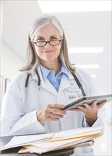 Caucasian doctor holding digital tablet in hospital