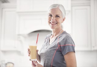 Caucasian woman posing with smoothie