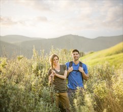Portrait of Caucasian couple hiking on hill