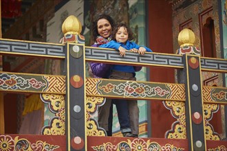 Mixed Race mother holding son on balcony