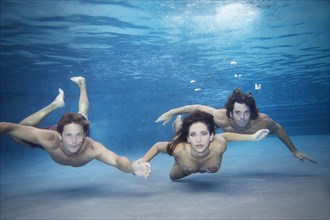 Friends swimming together under water