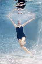 Caucasian woman swimming underwater