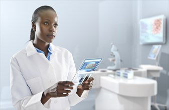 African American doctor using digital tablet in laboratory