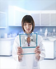 Mixed race doctor using digital tablet in a lab