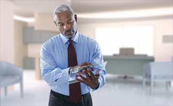 Black businessman using digital tablet