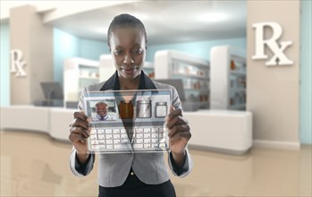 African American businesswoman using digital display in pharmacy