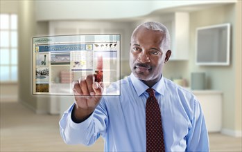 Black businessman using digital display in office