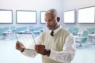 Black businessman using digital tablet in conference room