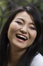 Confident Japanese woman laughing