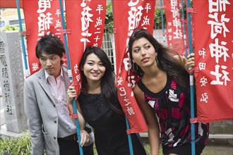 Japanese friends posing with flags