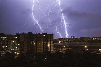Lightning striking city at night