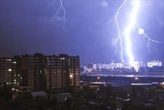 Lightning striking city at night