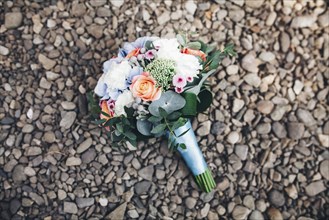 Bouquet of flowers laying on rocks