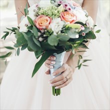Caucasian bride holding bouquet of flowers