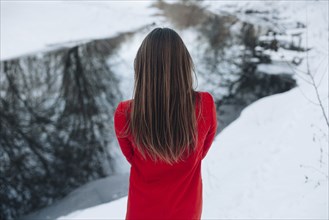 Rear view of Caucasian woman with long hair in snow
