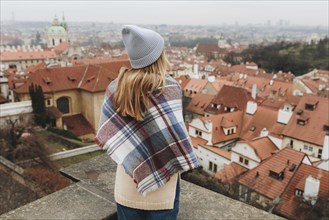 Caucasian woman admiring cityscape from rooftop