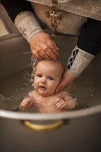 Caucasian baby boy being baptized