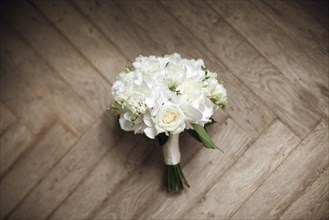 Bouquet of white roses on floor