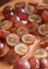 Sliced grapes on wooden board