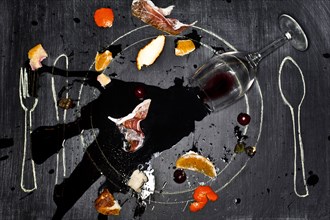 Wine glass and food spilled onto chalkboard